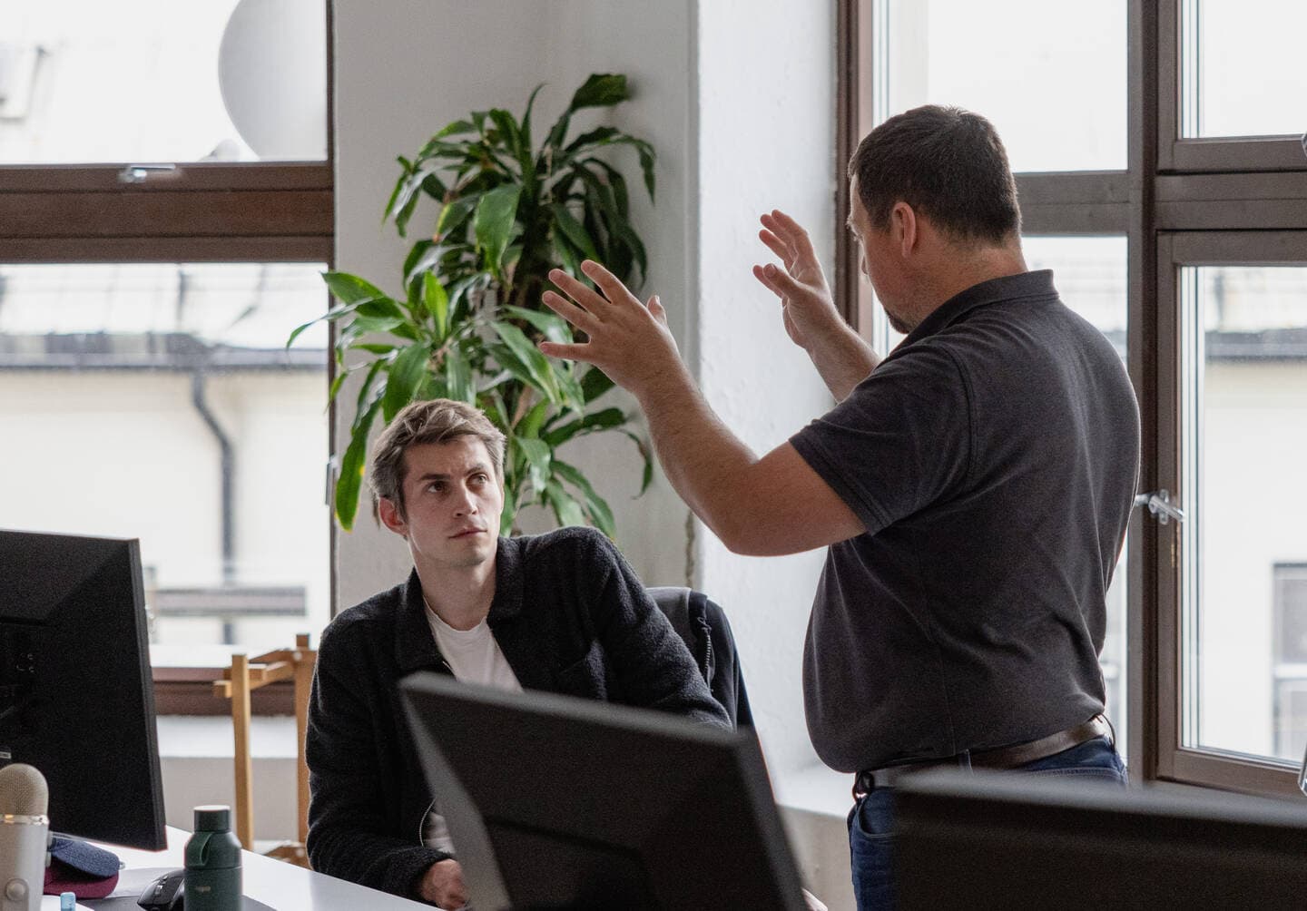 Two people gesturing in a lively discussion.